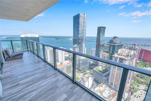 a view of a balcony with wooden chairs