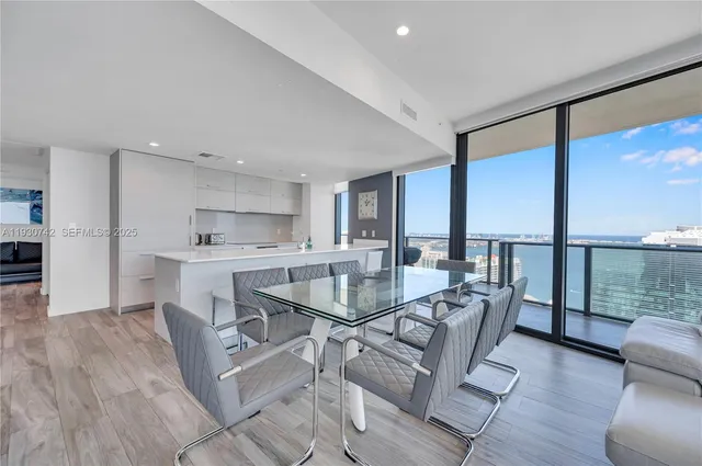 a dining room with furniture window and wooden floor