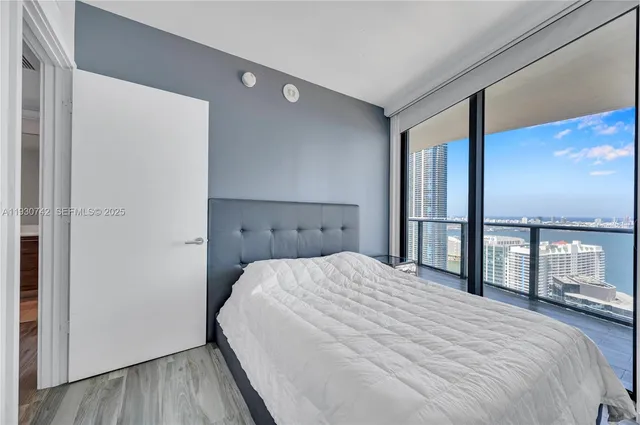 a bedroom with a large bed and a large window