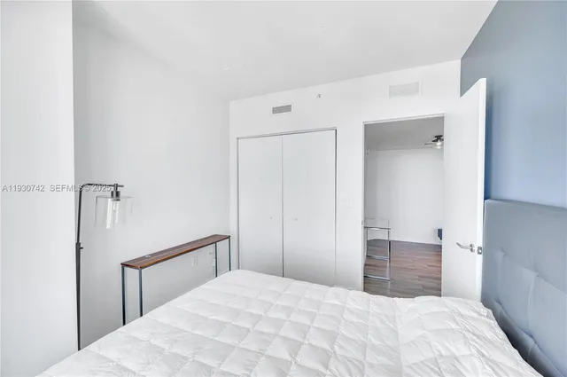 a bedroom with a bed and a shower