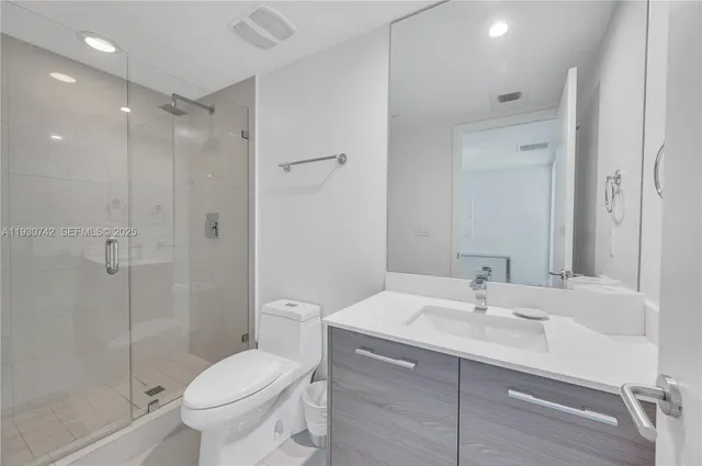 a bathroom with a sink toilet and shower