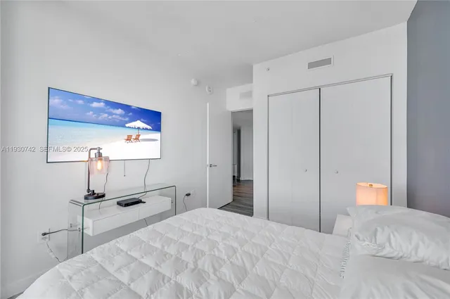 a bedroom with a bed and a dresser