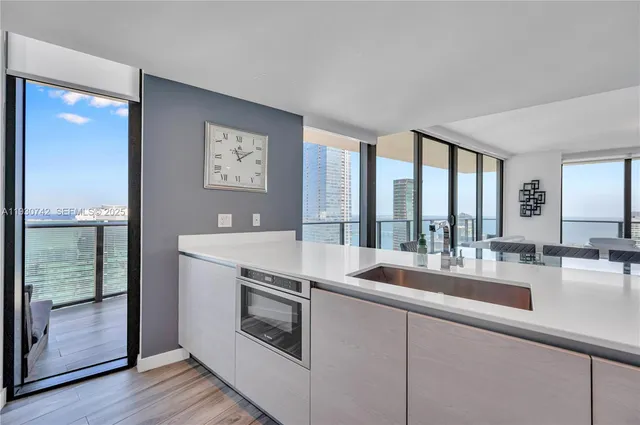 a kitchen with a stove a sink and a refrigerator