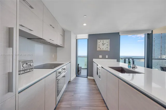 a large kitchen with a sink and cabinets