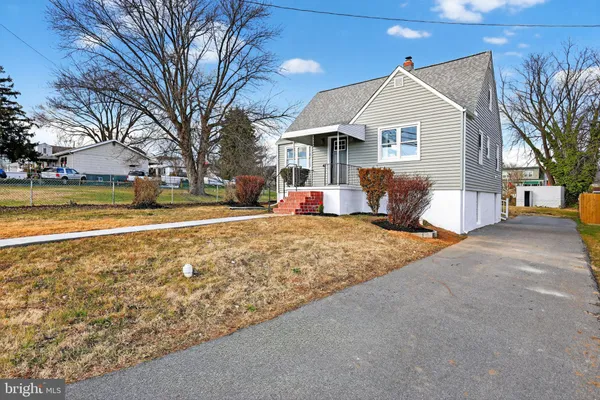 a front view of a house with a yard and fountain