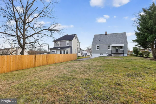 a view of house with yard and large tree