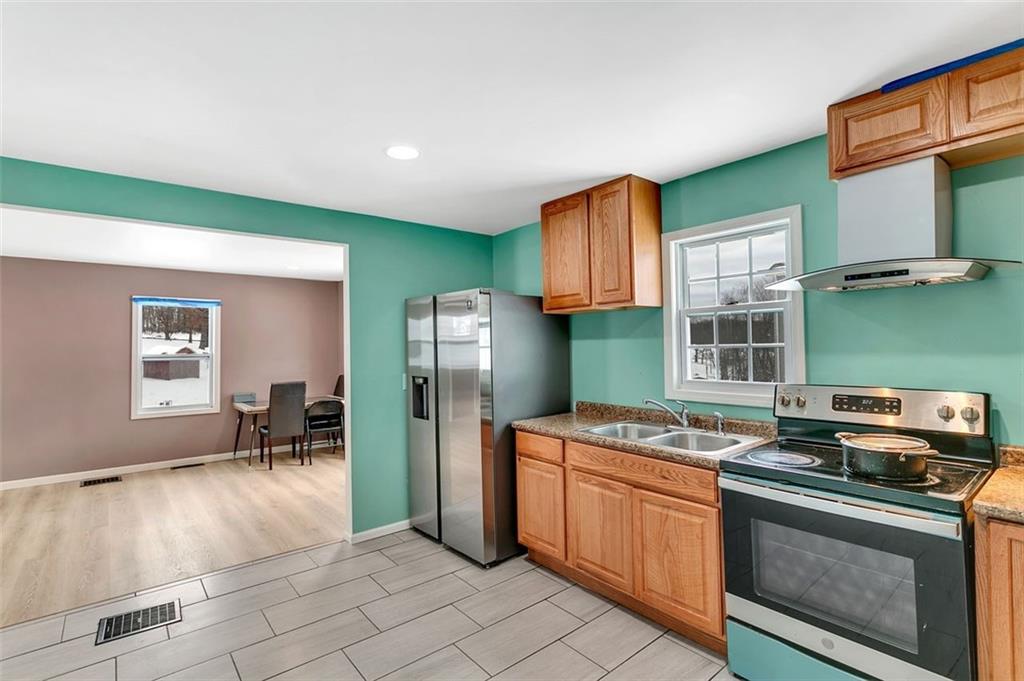 742 Jackson Road Apollo, PA 15613 - Photo 13 of 20 a kitchen with stainless steel appliances granite countertop a stove a sink and a refrigerator