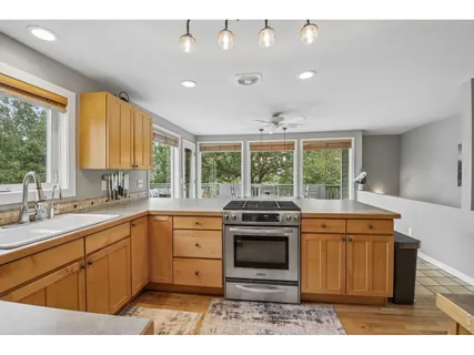 a kitchen with a stove sink and cabinets