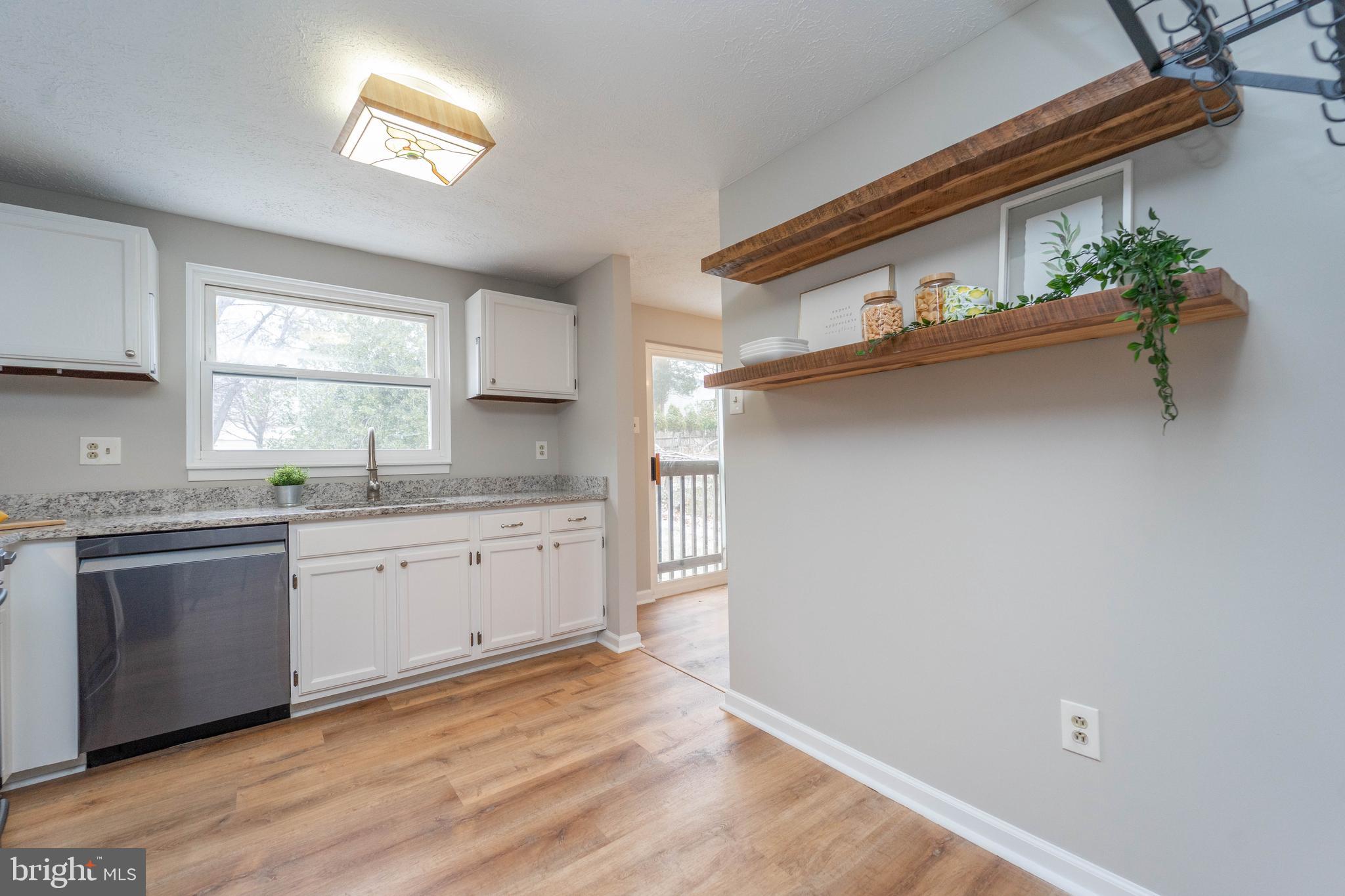 6922 Pinecrest Road Catonsville, MD 21228 - Photo 11 of 36 a kitchen with cabinets a window and appliances