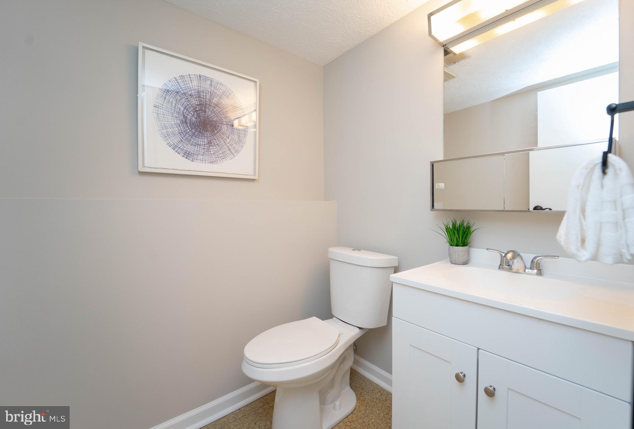 6922 Pinecrest Road Catonsville, MD 21228 - Photo 18 of 36 a bathroom with a toilet sink and mirror