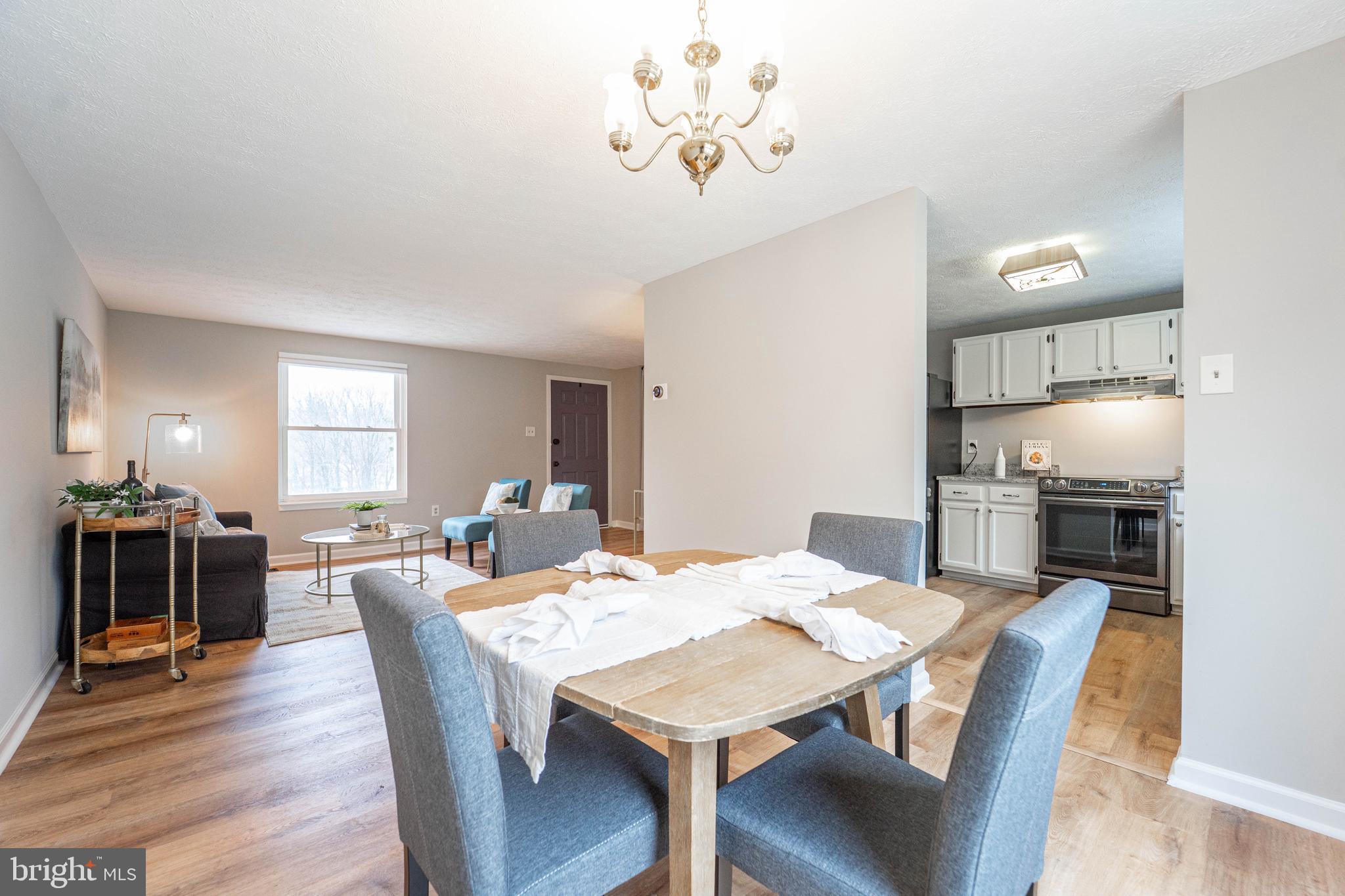 6922 Pinecrest Road Catonsville, MD 21228 - Photo 6 of 36 a view of a dining room with furniture and wooden floor