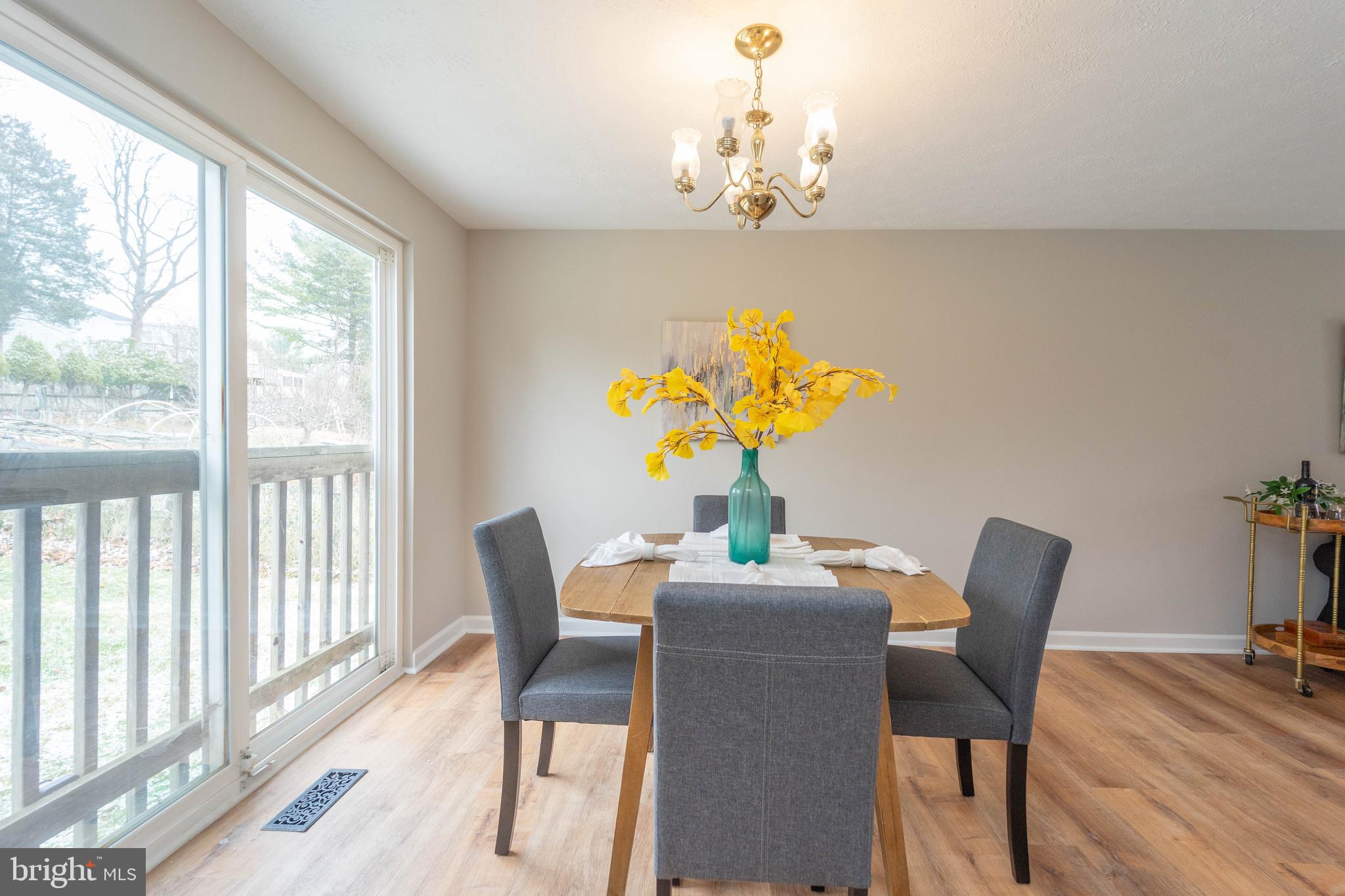 6922 Pinecrest Road Catonsville, MD 21228 - Photo 7 of 36 a dining room with furniture a rug a potted plant and a chandelier