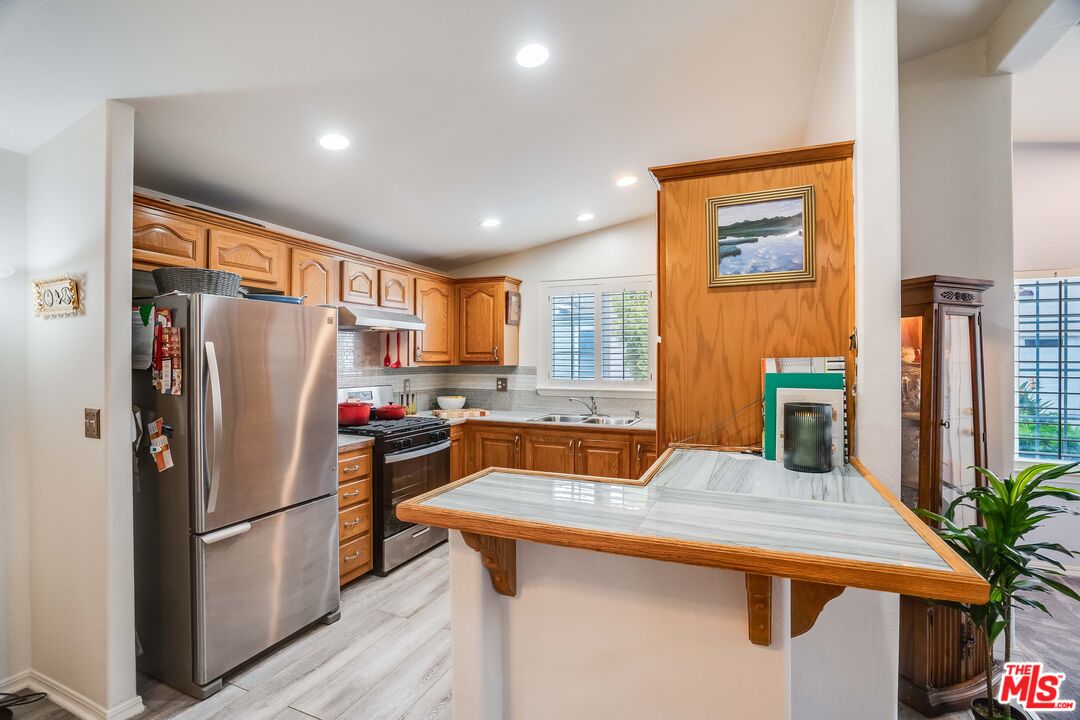 146 Apache Topanga, CA 90290 - Photo 7 of 21 a kitchen with stainless steel appliances a refrigerator and a stove