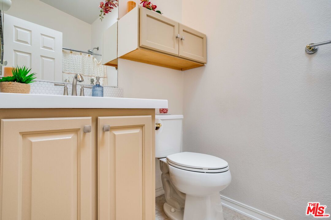 146 Apache Topanga, CA 90290 - Photo 8 of 21 a bathroom with a toilet a sink and mirror