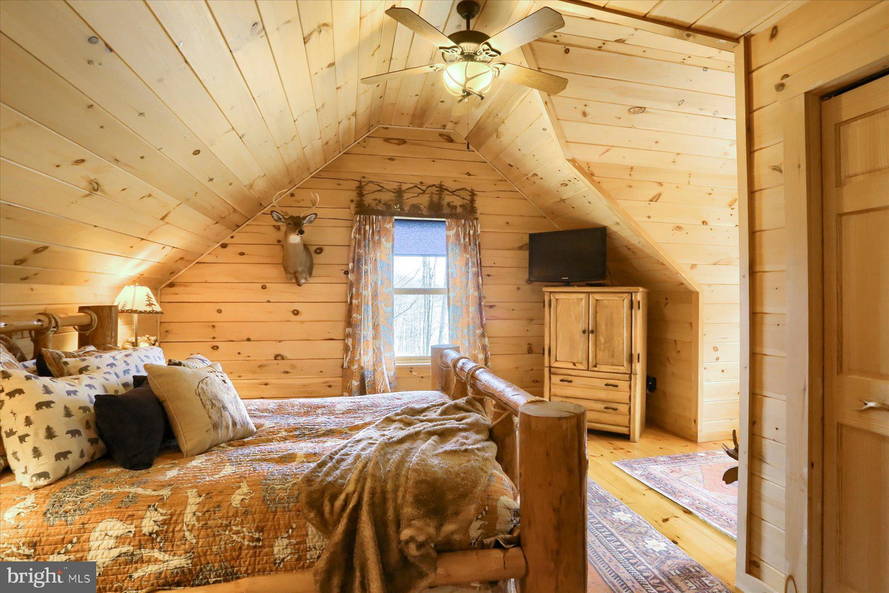 1560 Rhine Hollow Road East Waterford, PA 17021 - Photo 25 of 113 a bedroom with a bed and wooden floor