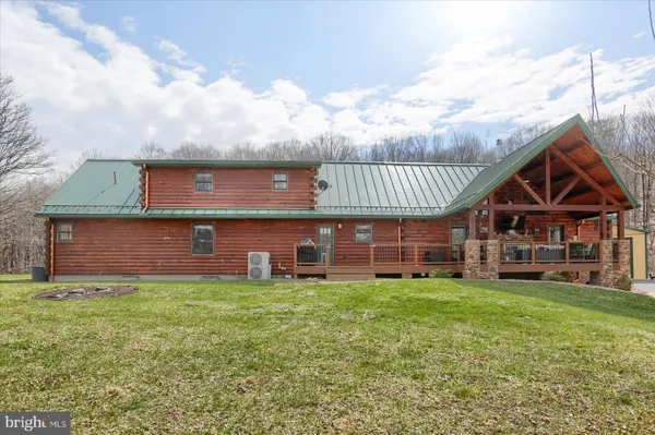 a view of a dining room with furniture and a chandelier