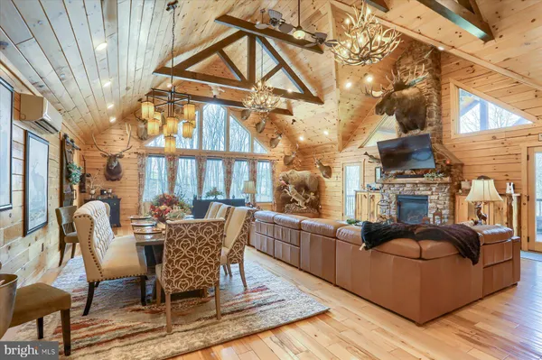 a kitchen with stainless steel appliances granite countertop a refrigerator a sink dishwasher a stove top oven a refrigerator with island and chairs