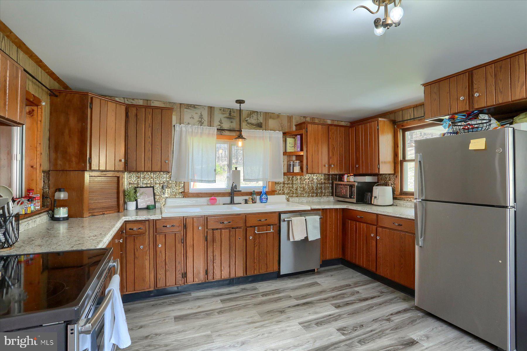 1560 Rhine Hollow Road East Waterford, PA 17021 - Photo 78 of 113 a kitchen with stainless steel appliances granite countertop a refrigerator a sink dishwasher a stove top oven a refrigerator with island and chairs