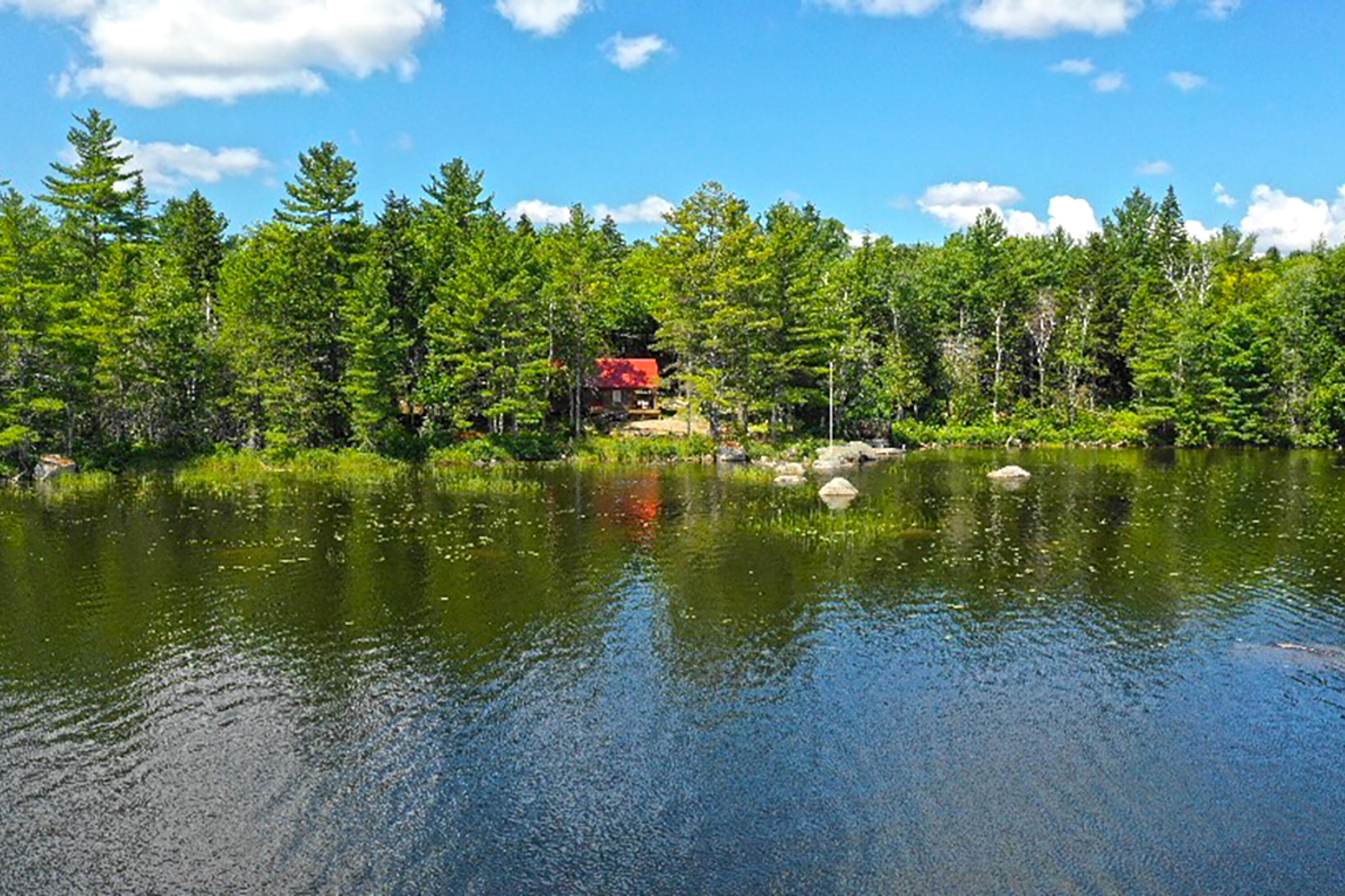 560-3 Off Comstock Road Aurora, ME 04408 - Photo 2 of 16 View of Cabin from the Lake