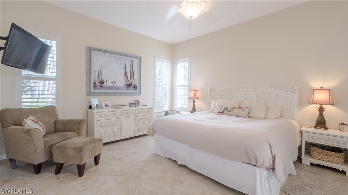 8734 Brittania Drive Fort Myers, FL 33912 - Photo 11 of 34 a bedroom with bed furniture and flat screen tv