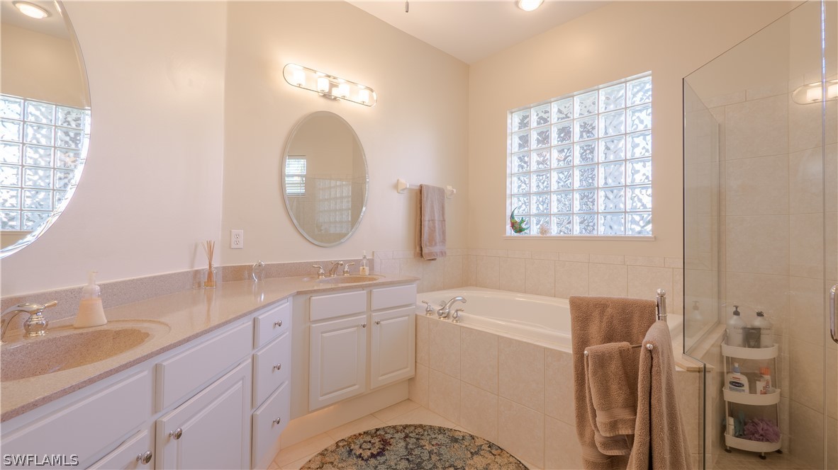 8734 Brittania Drive Fort Myers, FL 33912 - Photo 14 of 34 a spacious bathroom with a double vanity sink mirror and