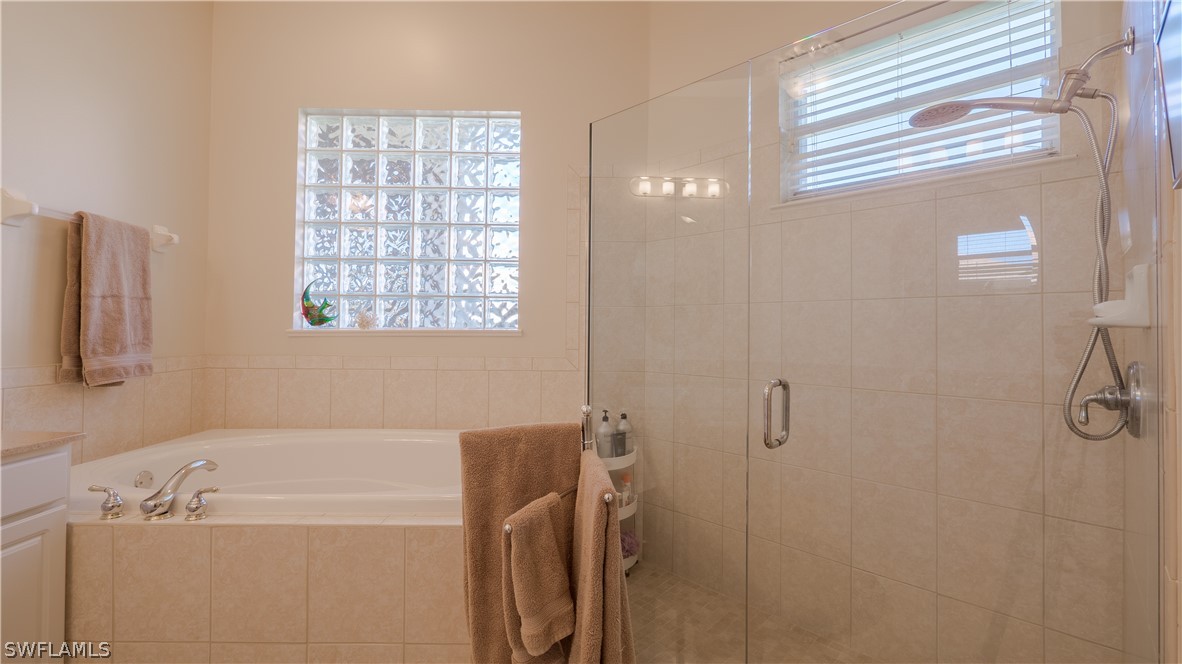 8734 Brittania Drive Fort Myers, FL 33912 - Photo 15 of 34 a bathroom with a tub a sink and a window