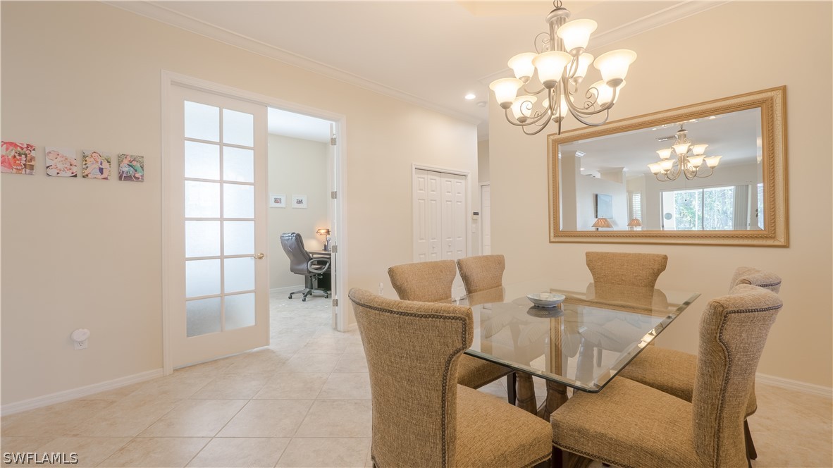 8734 Brittania Drive Fort Myers, FL 33912 - Photo 18 of 34 a view of a dining room with furniture and chandelier
