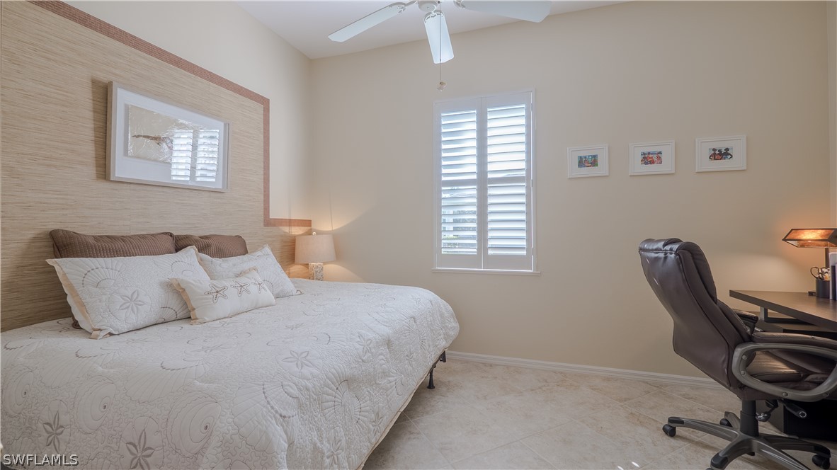 8734 Brittania Drive Fort Myers, FL 33912 - Photo 19 of 34 a bedroom with a bed a desk and chair