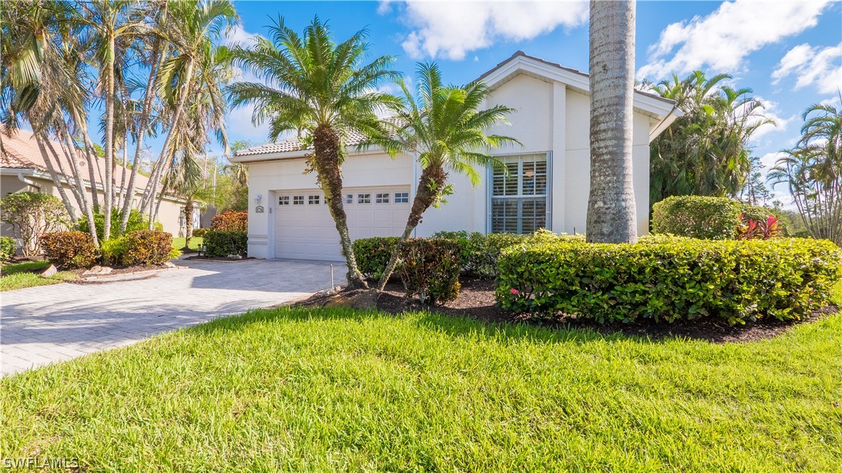 8734 Brittania Drive Fort Myers, FL 33912 - Photo 2 of 34 a front view of a house with a garden