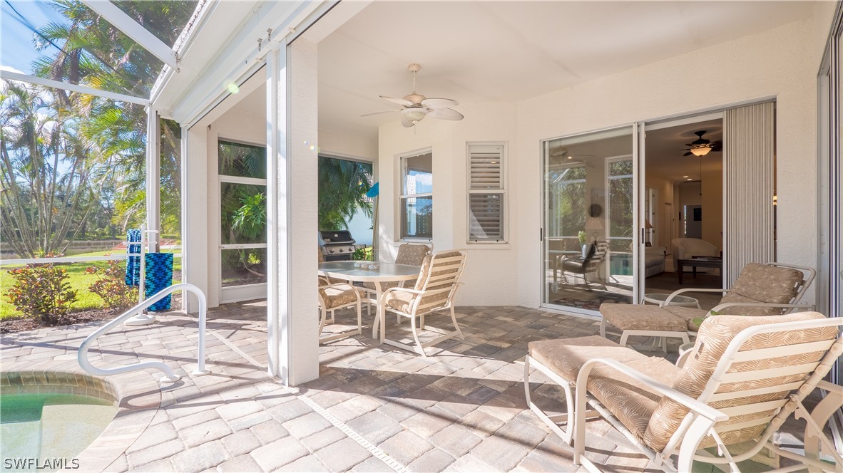 8734 Brittania Drive Fort Myers, FL 33912 - Photo 24 of 34 a view of a patio with a dining table and chairs