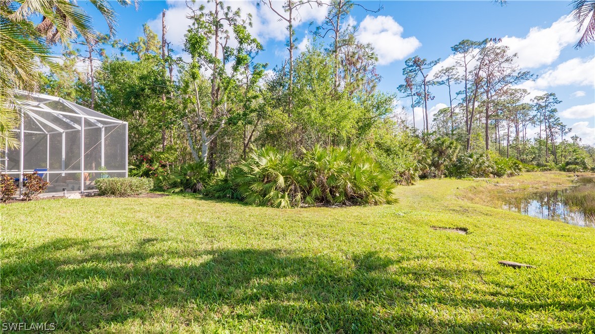 8734 Brittania Drive Fort Myers, FL 33912 - Photo 28 of 34 a view of yard with swimming pool and green space