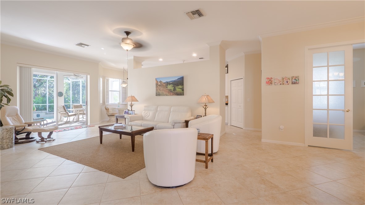 8734 Brittania Drive Fort Myers, FL 33912 - Photo 4 of 34 a living room with furniture a large window and a chandelier