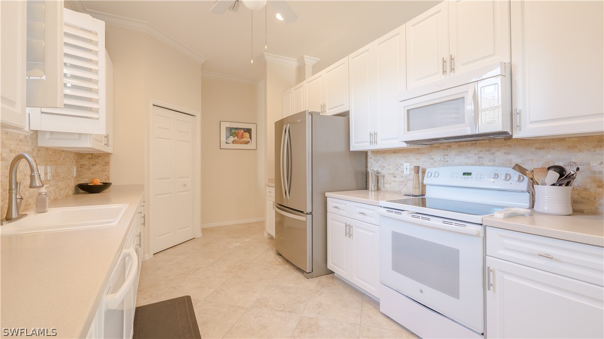 8734 Brittania Drive Fort Myers, FL 33912 - Photo 7 of 34 a kitchen with a sink stove and refrigerator