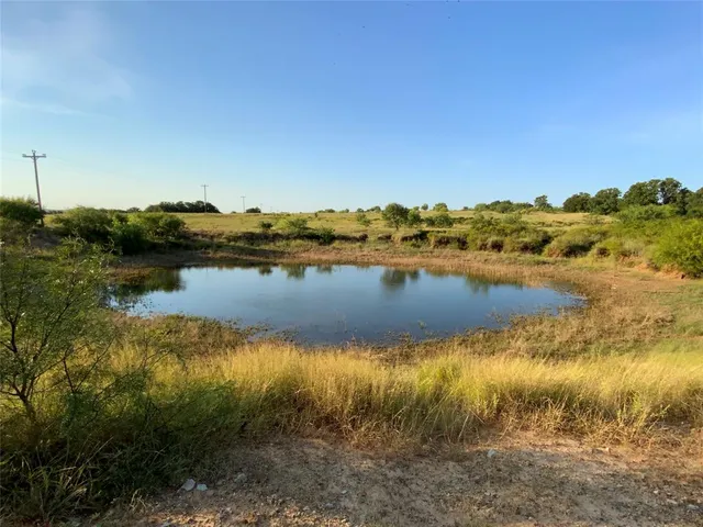a view of a lake with houses in the back