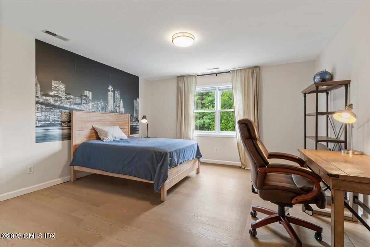 5 Sunshine Avenue Riverside, CT 06878 - Photo 21 of 35 a bedroom with a bed wooden floor and a window