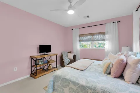 a bedroom with a bed and a flat screen tv