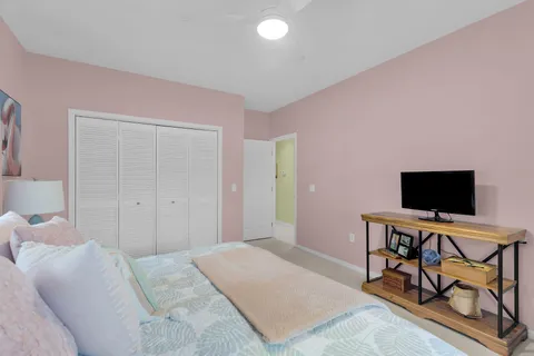 a bedroom with a bed and a flat screen tv on the table