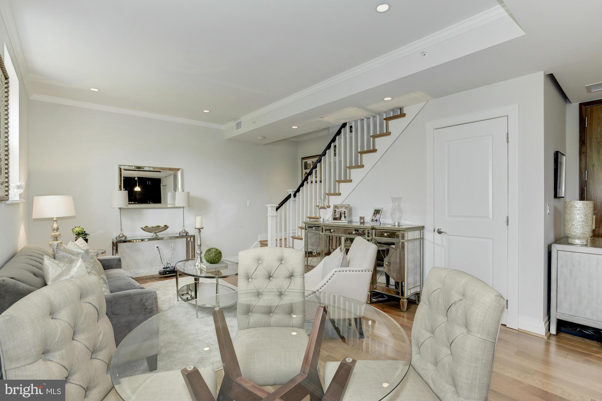 3052 R Street Northwest, Unit 304 Washington, DC 20007 - Photo 2 of 19 a living room with furniture and a flat screen tv