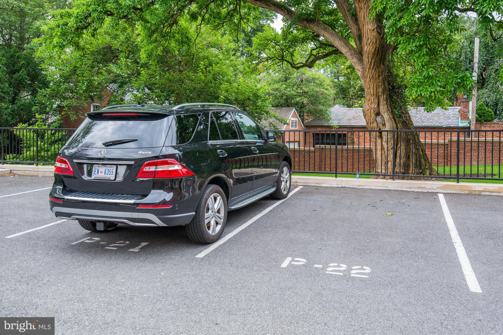 3052 R Street Northwest, Unit 304 Washington, DC 20007 - Photo 11 of 19 a car parked in parking area next to a yard