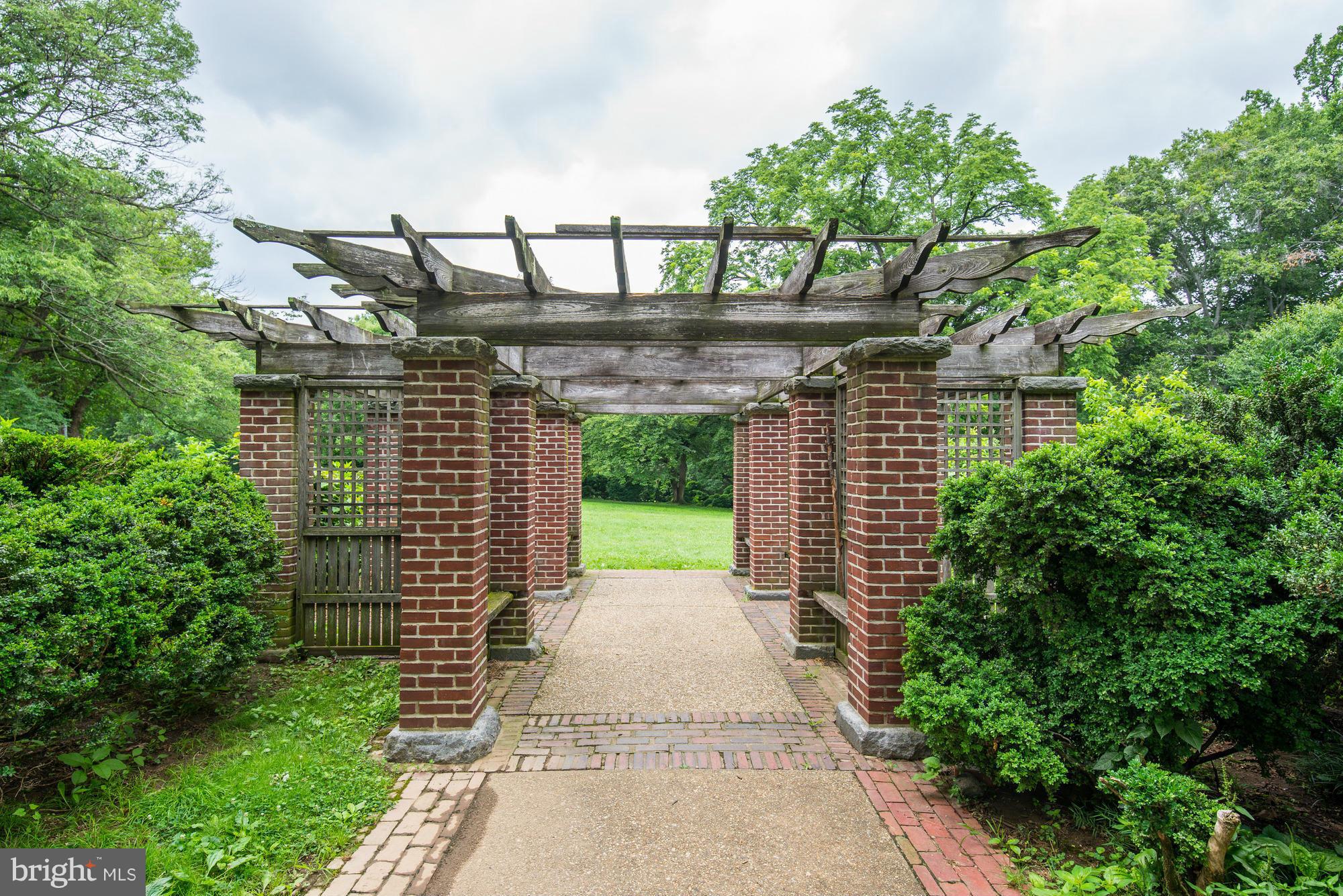 3052 R Street Northwest, Unit 304 Washington, DC 20007 - Photo 15 of 19 a view of a pathway of a building with large trees