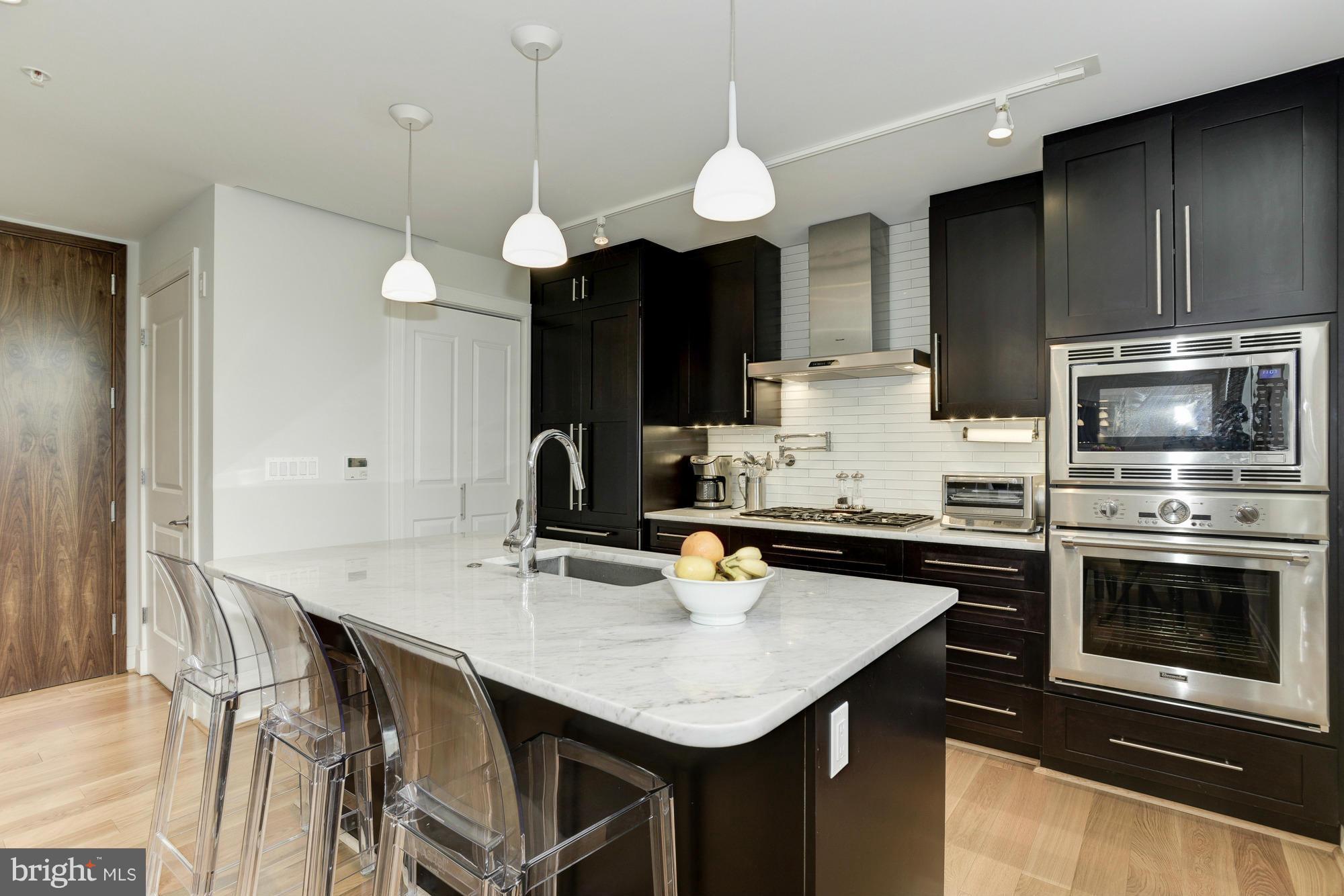 3052 R Street Northwest, Unit 304 Washington, DC 20007 - Photo 3 of 19 a kitchen with stainless steel appliances a stove a sink and a refrigerator