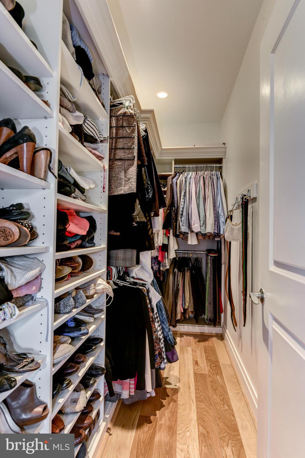 3052 R Street Northwest, Unit 304 Washington, DC 20007 - Photo 7 of 19 a view of walk in closet with clothes and shoes