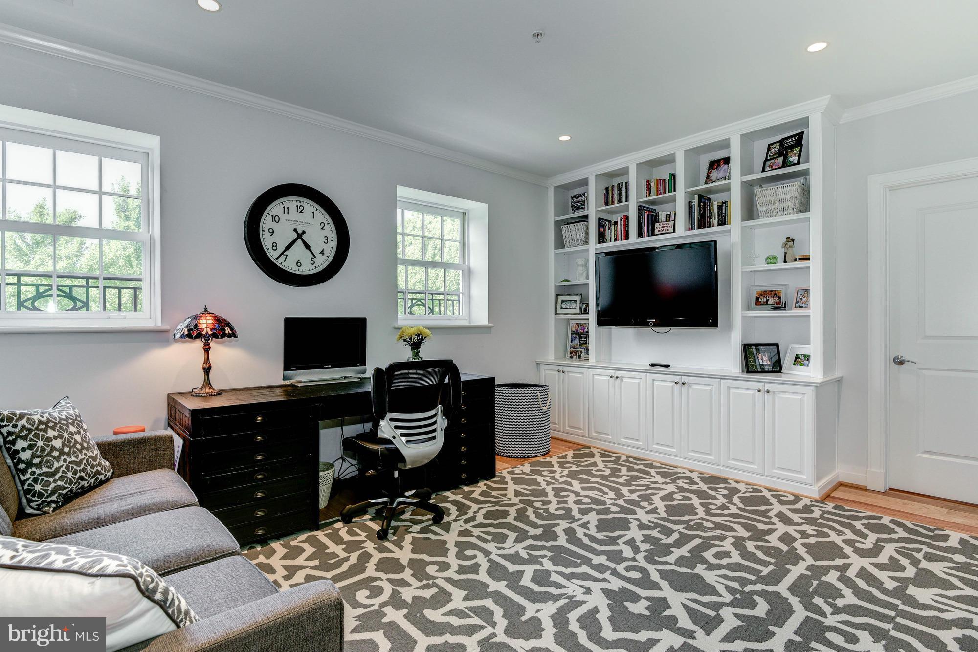 3052 R Street Northwest, Unit 304 Washington, DC 20007 - Photo 9 of 19 a living room with furniture a flat screen tv and a window