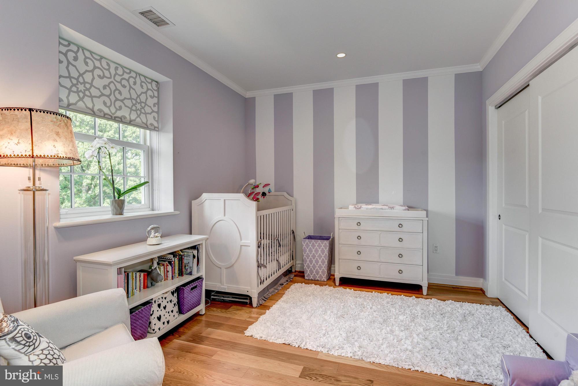 3052 R Street Northwest, Unit 304 Washington, DC 20007 - Photo 10 of 19 a living room with furniture and a baby crib