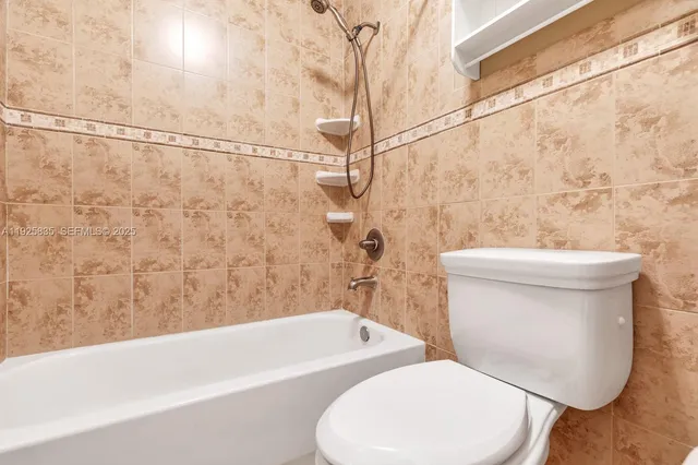 a bathroom with a toilet and a bathtub