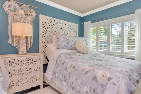 a dining room with wooden floor a chandelier a wooden table and chairs