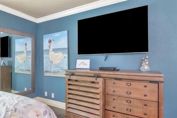 an empty room with wooden floor closet and windows