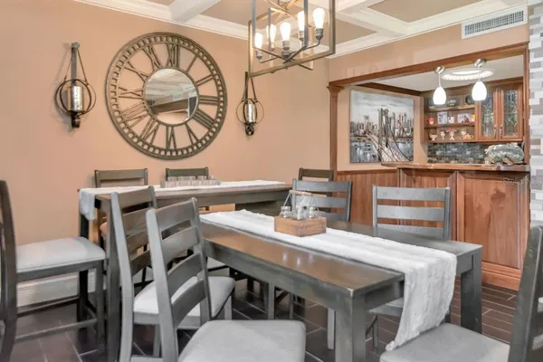 a view of a dining room with furniture wooden floor and chandelier