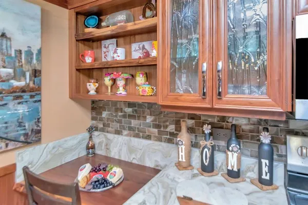 an aerial view of a house with a yard and large trees