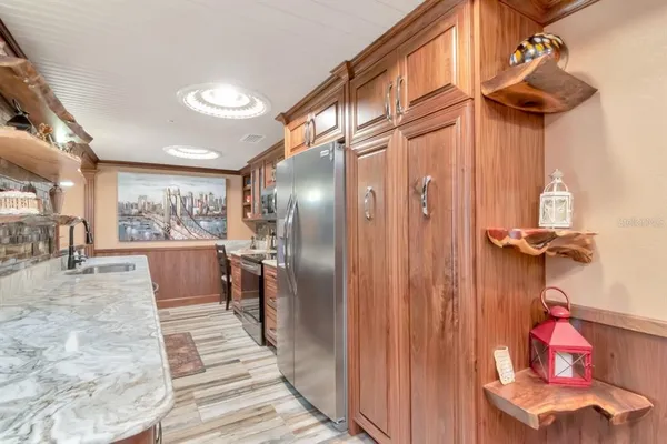 a bedroom with a large bed and a chandelier